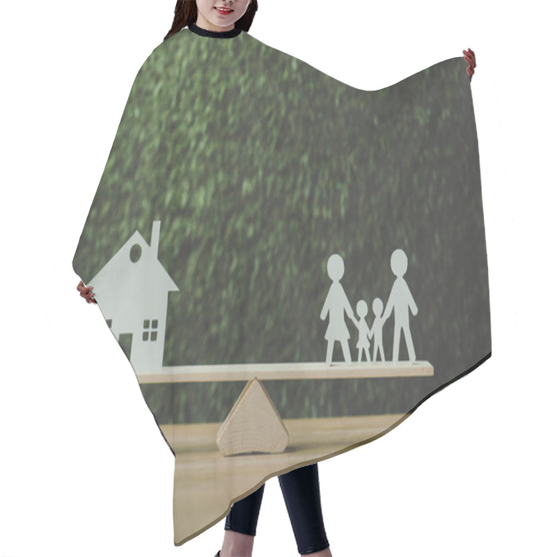 Personality  Paper Cut House And Paper Family Balancing On Seesaw On Green Background Hair Cutting Cape