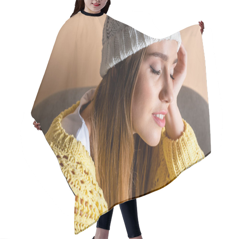 Personality  Attractive Tender Girl With Closed Eyes In Yellow Sweater And Hat Sitting In Armchair On Beige Hair Cutting Cape