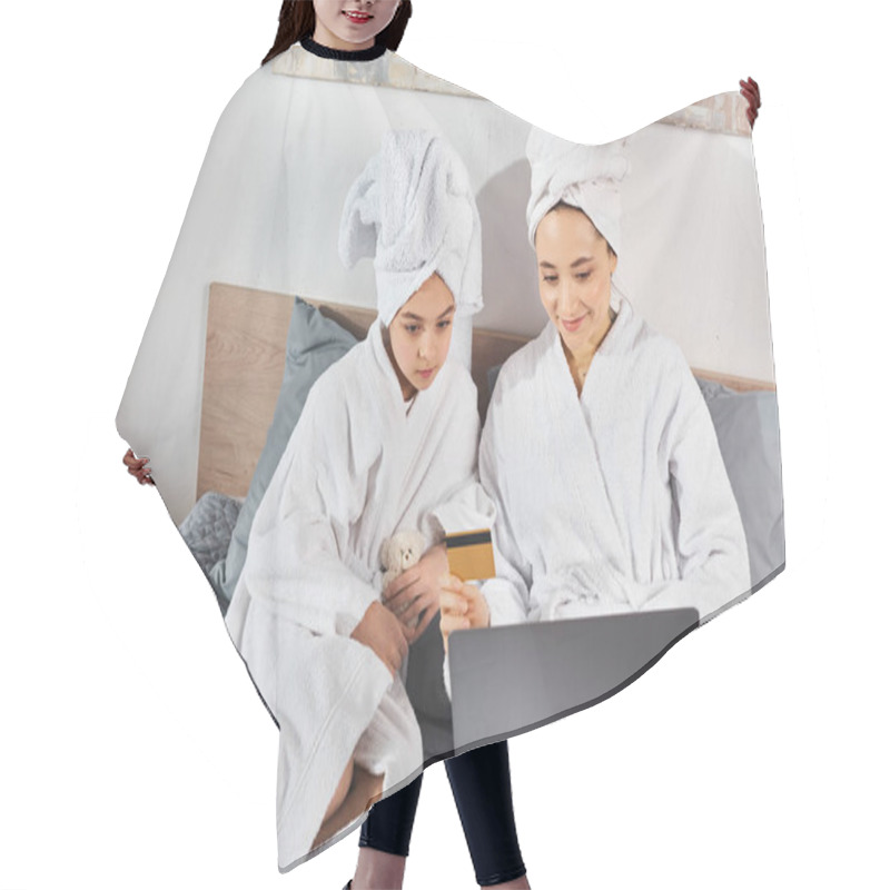 Personality  Two Women, A Brunette Mother, And Daughter, In White Bath Robes Sitting On A Bed, Engaged With A Laptop. Hair Cutting Cape