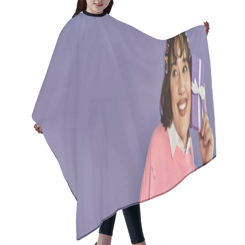 Personality  A Joyful Woman Holds A Purple Gift Box To Her Ear With A Big Smile. Hair Cutting Cape