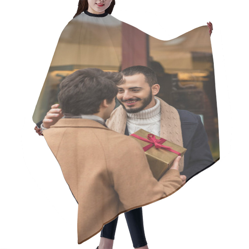 Personality  Pleased Bearded Gay Man Smiling Near Boyfriend With Christmas Gift Box And Blurred Showcase Hair Cutting Cape