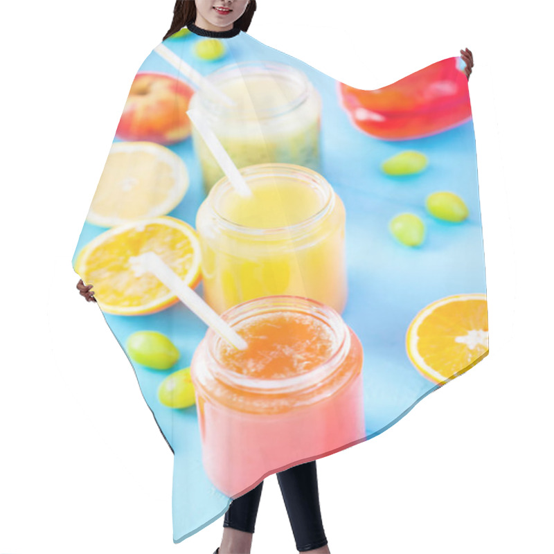 Personality  Freshly Squeezed Fruit Juice, Smoothies Yellow Orange Green Blue Banana Lemon Apple Orange Kiwi Grape Strawberry On Bright Blue Background Close Up. Hair Cutting Cape