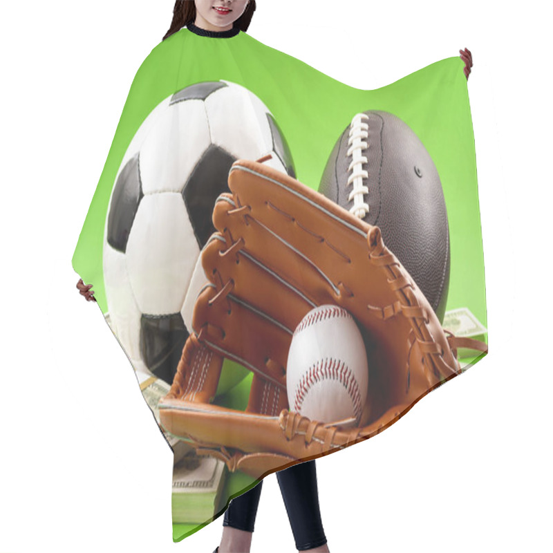 Personality  Winning Bet On Sporting Event, Money In Sport And Sports Betting Conceptual Idea With Baseball Glove, Football, Soccer Ball And Wad Of Cash Isolated On Green Background Hair Cutting Cape