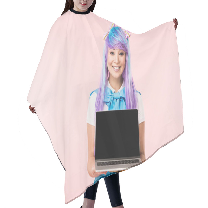 Personality  Smiling Asian Anime Girl In Wig Showing Laptop With Blank Screen Isolated On Pink Hair Cutting Cape