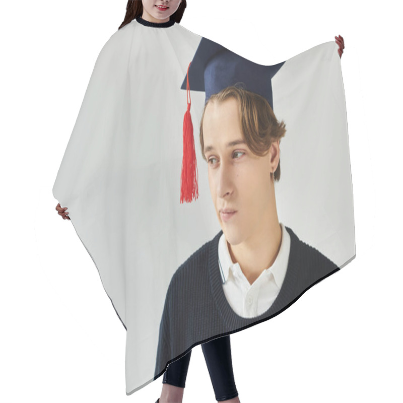 Personality  A Handsome Young Student Poses Confidently In A Studio While Celebrating His Graduation. Hair Cutting Cape