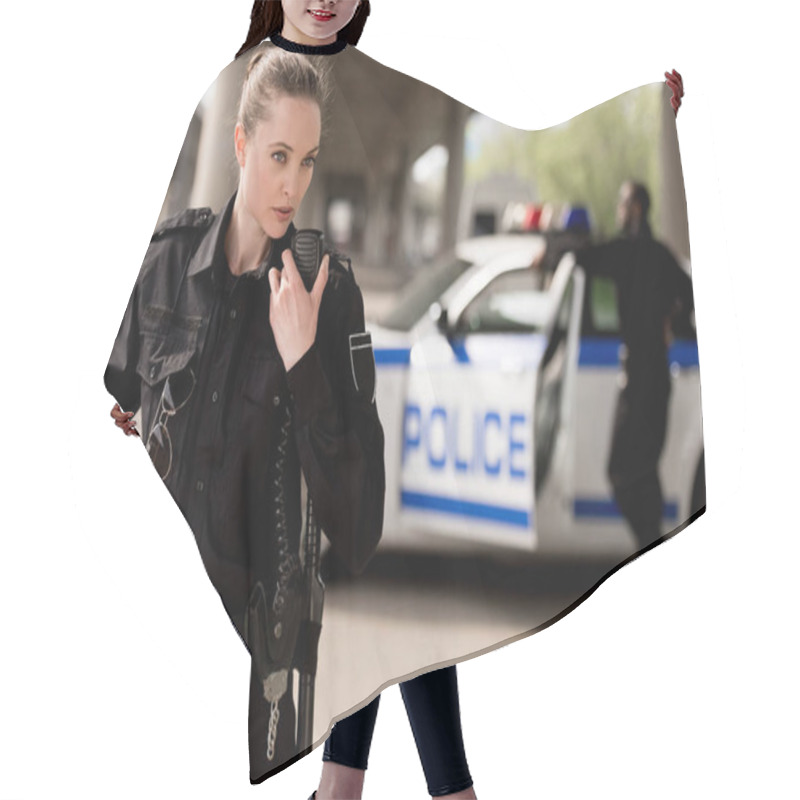 Personality  Young Attractive Policewoman Using Walkie-talkie With Blurred Partner Near Car On Background Hair Cutting Cape