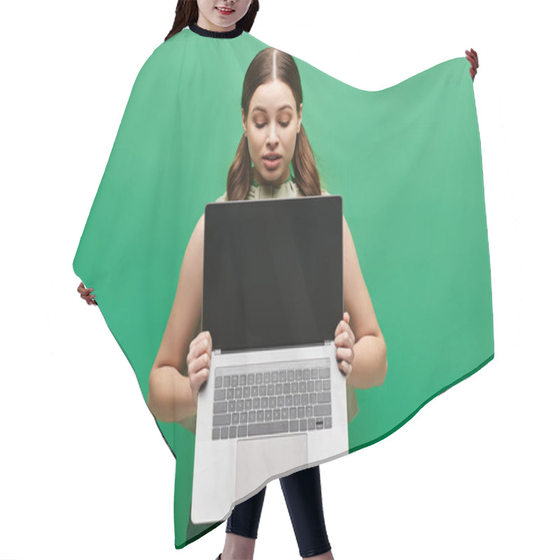 Personality  A Young Woman In Her 20s Holds A Laptop In Front Of Her Face, Concealing Her Identity In A Studio Setting. Hair Cutting Cape