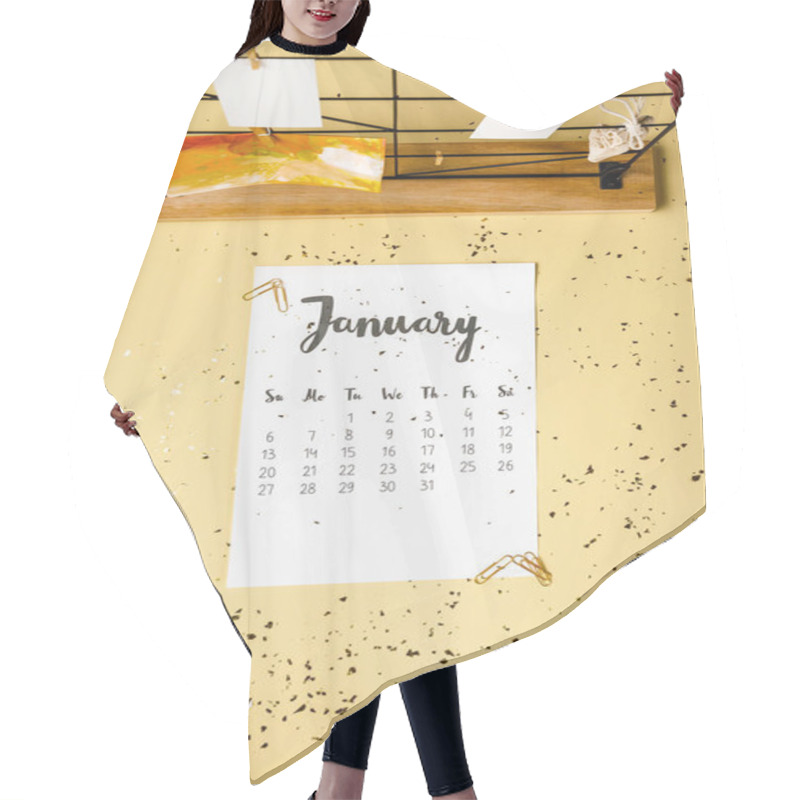 Personality  Top View Of January Calendar With Golden Confetti And Cards With Clothespins On Beige Hair Cutting Cape