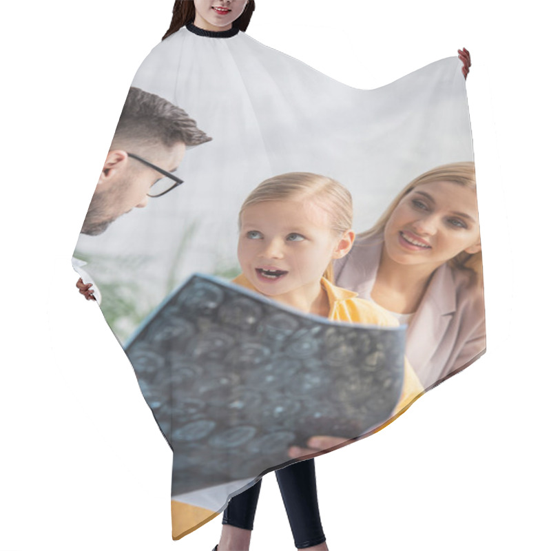 Personality  Amazed Kid Looking At Family Doctor With Mri Scan Near Smiling Mother  Hair Cutting Cape