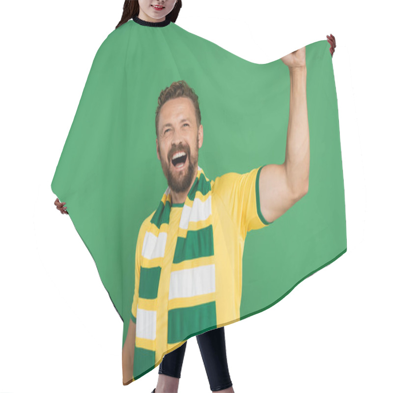 Personality  Emotional Sports Fan In Striped Scarf And Yellow T-shirt Rejoicing Isolated On Green  Hair Cutting Cape