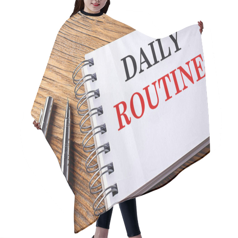 Personality  DAILY ROUTINE Text On A Notebook With Pen On Wooden Background Hair Cutting Cape