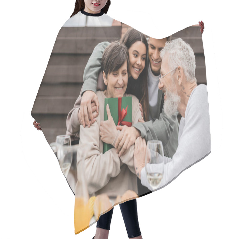 Personality  Cheerful Kids Hugging Positive Mother Holding Gift Box Near Father And Summer Food During Barbeque Party And Parents Day Celebration At Backyard In June, Celebrating Parenthood Day Concept Hair Cutting Cape