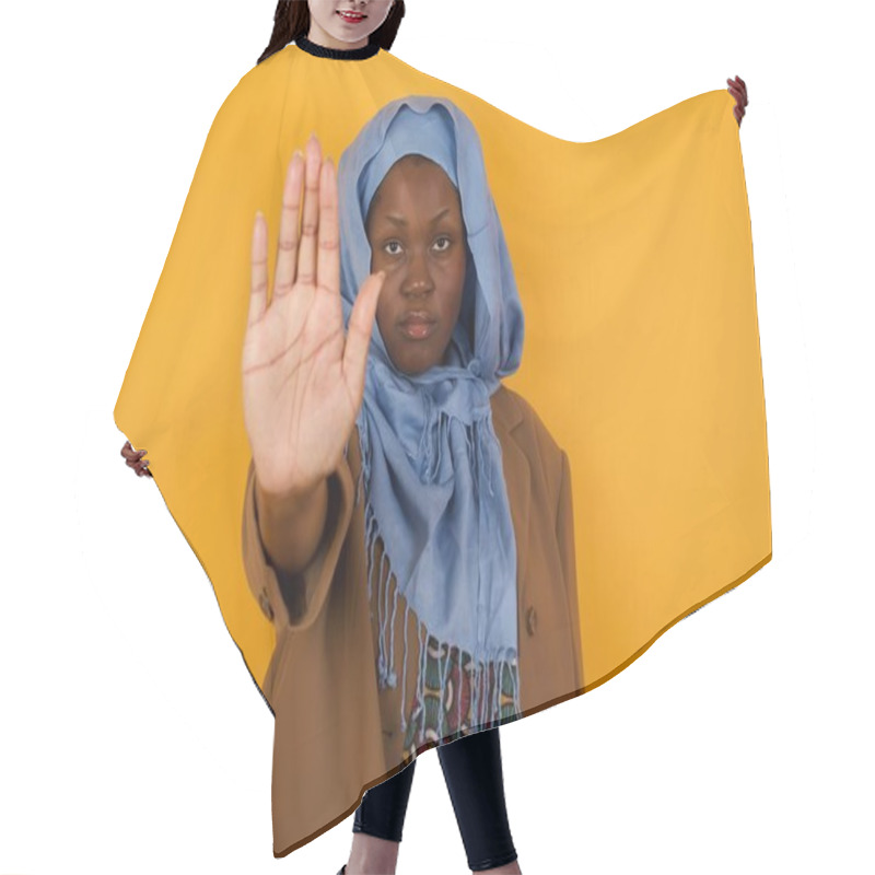 Personality  Young Beautiful African American Muslim Woman Doing Stop Gesture With Palm Of The Hand. Warning Expression With Negative And Serious Gesture On The Face Isolated Over Yellow Background. Hair Cutting Cape