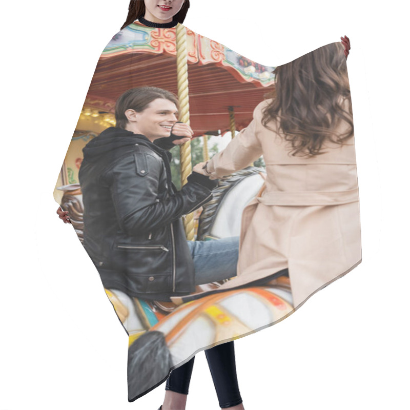 Personality  Happy Young Man Holding Hands With Girlfriend And Riding Carousel Horses In Amusement Park Hair Cutting Cape