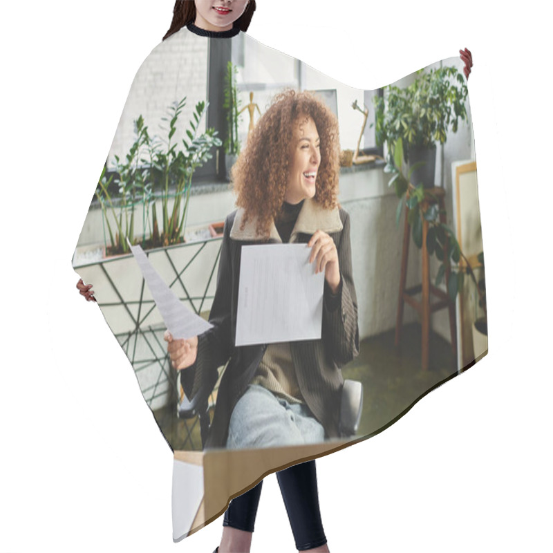 Personality  The Woman Smiles Brightly While Examining Important Paperwork In Her Lively Office Space. Hair Cutting Cape