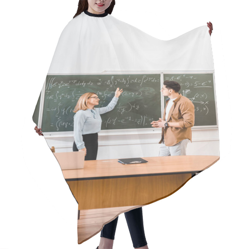 Personality  Female Teacher Pointing At Equations To Student In Classroom Hair Cutting Cape