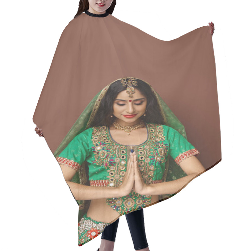 Personality  Attractive Indian Woman With Accessories And Bindi Dot Showing Praying Gesture And Looking Down Hair Cutting Cape