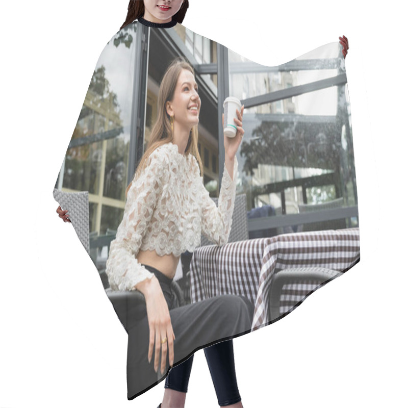 Personality  Positive Young Woman Holding Coffee To Go While Sitting At Table On Terrace Near Cafe In Berlin Hair Cutting Cape