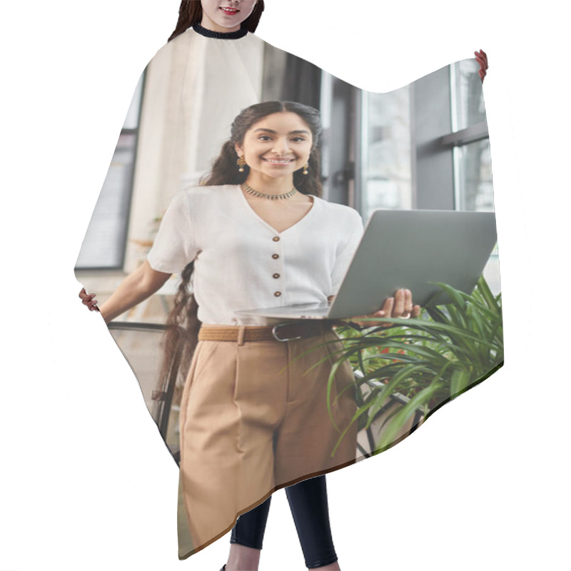 Personality  Young Indian Woman With Laptop Standing By Plant. Hair Cutting Cape