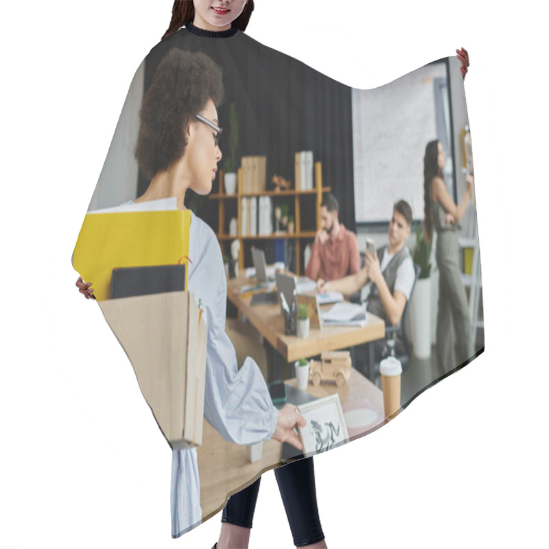 Personality  Stylish African American Woman Packing Her Items During Lay Off, Colleagues On Backdrop. Hair Cutting Cape