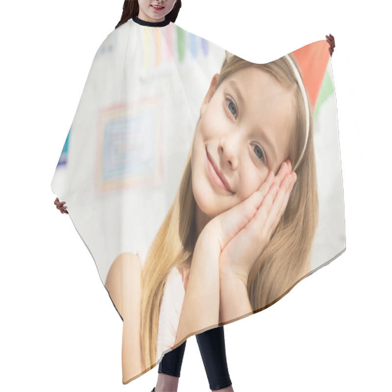 Personality  Adorable Smiling Kid In Party Cap Leaning Head On Hands And Looking At Camera At Home Hair Cutting Cape