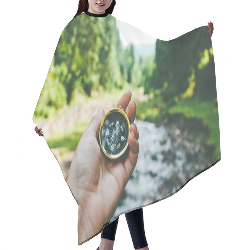 Personality  Compass In The Hand On The Nature Background.  Hair Cutting Cape