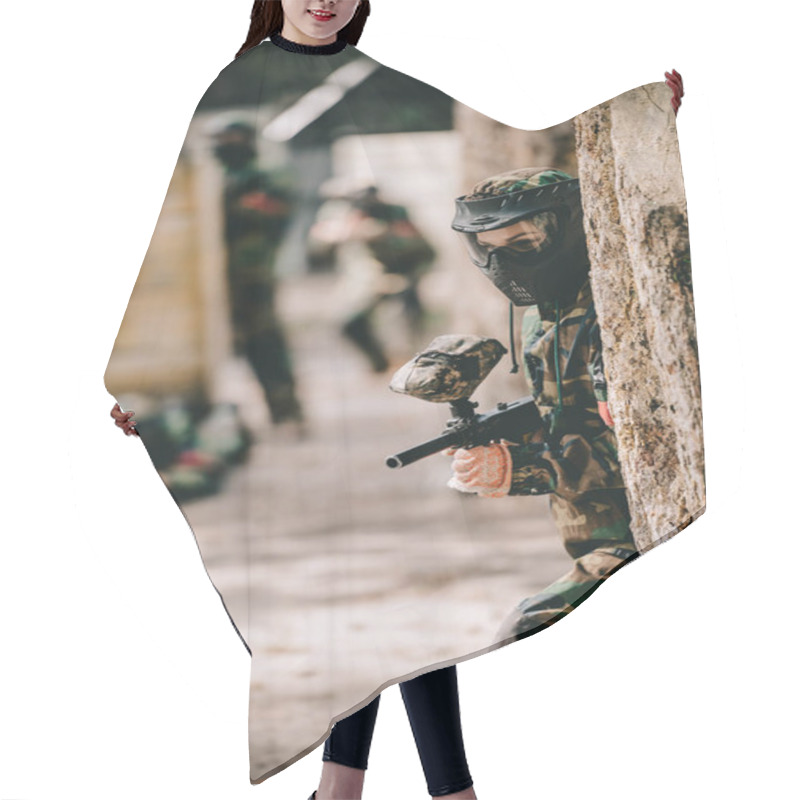 Personality  Selective Focus Of Female Paintball Player In Goggle Mask And Camouflage Aiming By Paintball Gun Near Tree Outdoors  Hair Cutting Cape