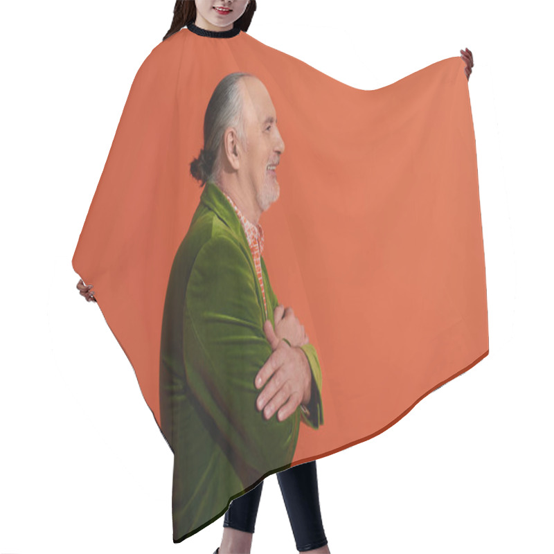 Personality  Side View Of Senior Male Model, Optimistic Man Posing With Folded Arms And Smiling On Red Orange Background, Green Velour Blazer, Grey Hair And Beard, Positive And Fashionable Aging Concept Hair Cutting Cape