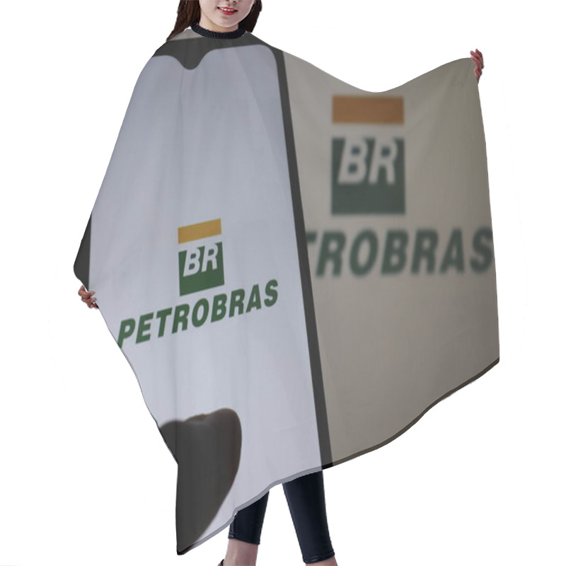 Personality  Bahia, Brazil - February 24, 2021: Petrobras Logo On Smartphone Screen. Investment Concept. Brazilian Oil And Gas Company. Hair Cutting Cape