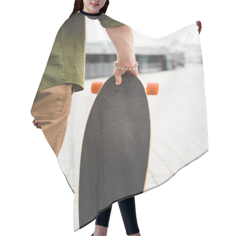 Personality  Cropped View Of Man In Casual Wear Standing With Skateboard In Hand Hair Cutting Cape