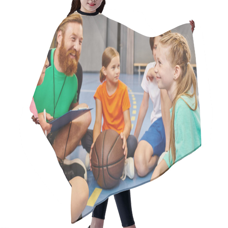 Personality  A Diverse Group Of Children Sit Attentively Around A Basketball As Their Male Teacher Instructs Them In A Bright, Lively Classroom Setting. Hair Cutting Cape