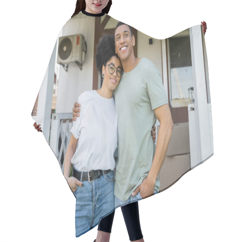 Personality  Positive African American Couple Hugging And Posing Near Blurred New House On Background Hair Cutting Cape