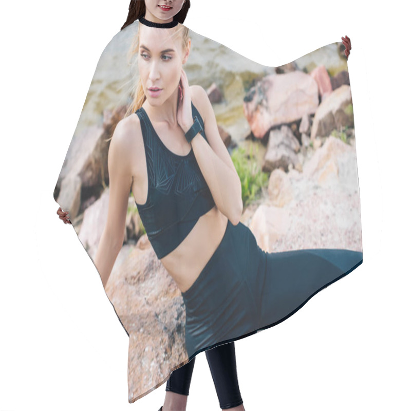 Personality  Attractive Sportswoman Sitting On Stone Near Sea And Touching Neck  Hair Cutting Cape