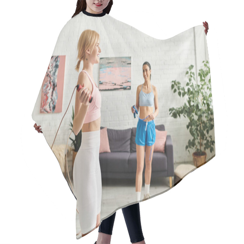 Personality  Two Young Women Enjoy A Playful Workout, Laughing Together In Their Cozy Living Space. Hair Cutting Cape