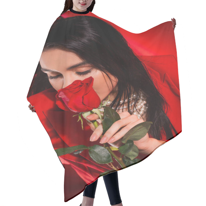 Personality  Brunette Woman In Pearl Necklace Holding Rose Near Face On Red Background  Hair Cutting Cape