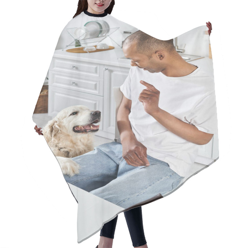 Personality  An African American Man In A Wheelchair And His Loyal Labrador Retriever Enjoying A Moment Together In The Kitchen. Hair Cutting Cape