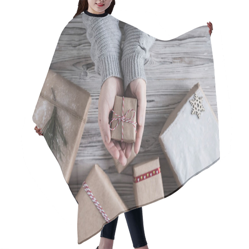 Personality  Female Packing Small Gift. Cardboard Box In Craft Paper, Christmas Rope And Tree On The Rustic Wood Planks Background. DIY. Hair Cutting Cape