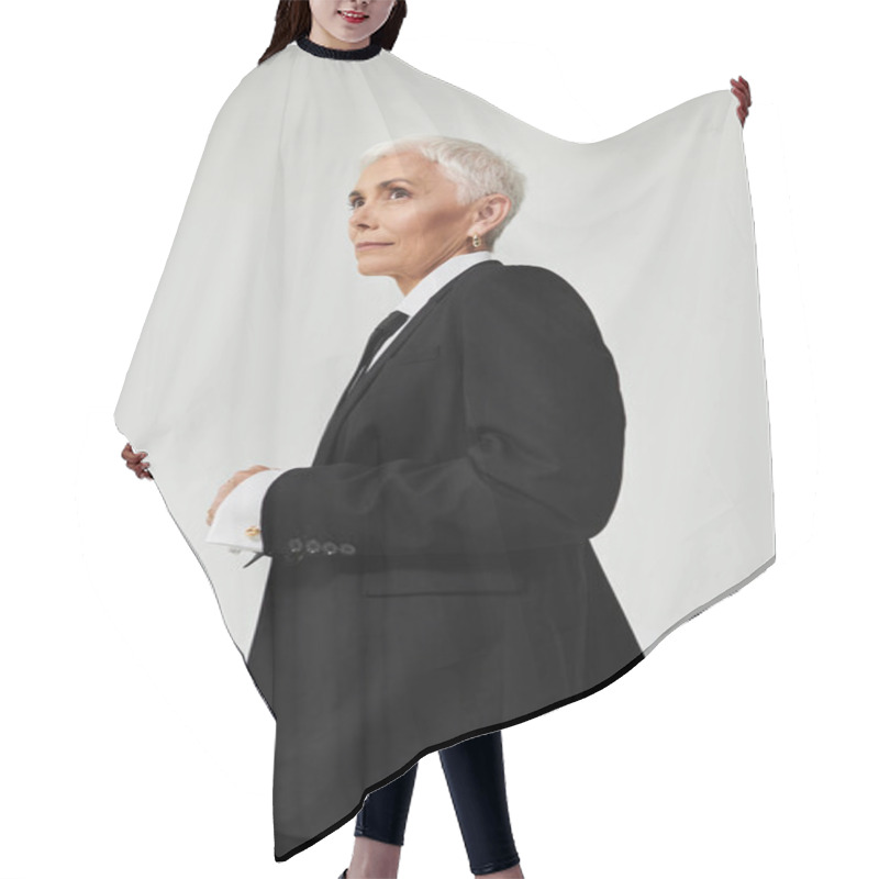 Personality  A Mature Woman With Short Hair Exudes Confidence In Fashionable Attire. Hair Cutting Cape