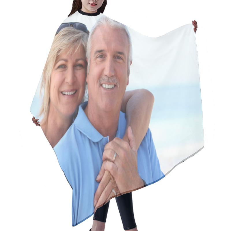 Personality  Middle Aged Couple At The Beach. Hair Cutting Cape