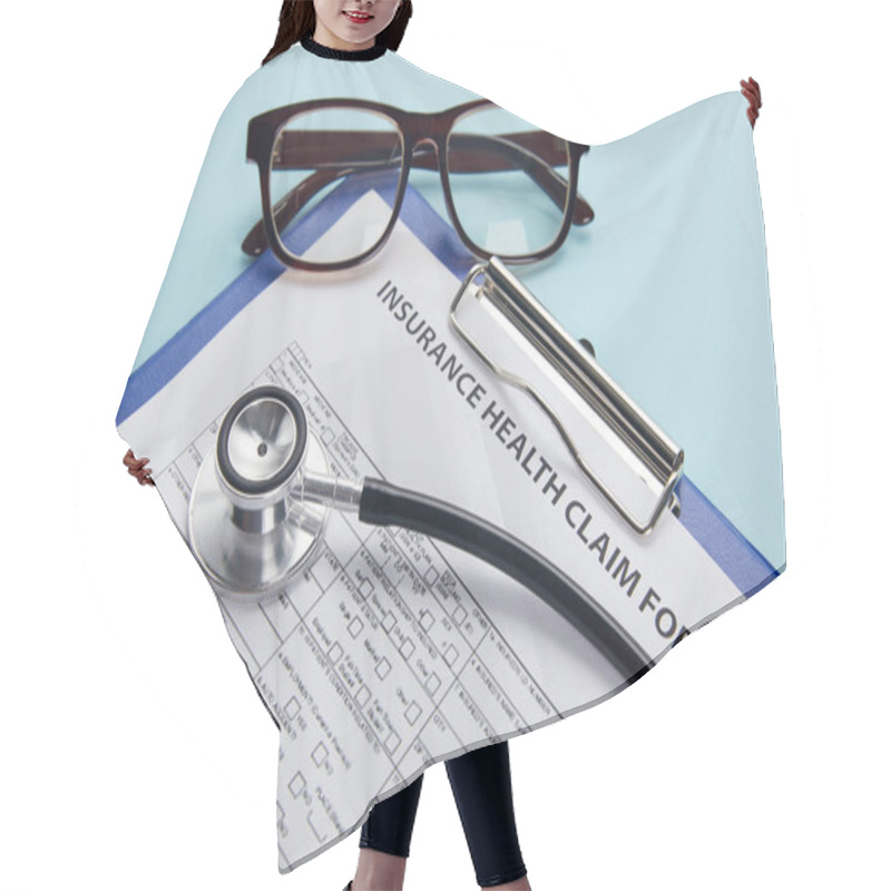 Personality  Insurance Health Claim Form, Clipboard, Eyeglasses And Stethoscope On Blue  Hair Cutting Cape