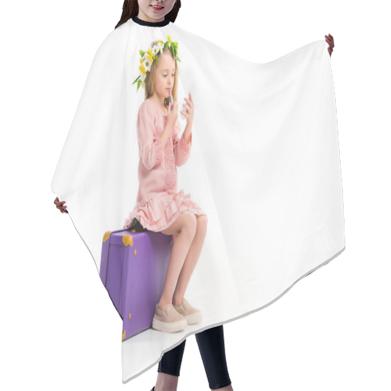 Personality  Side View Of Kid Sitting On Purple Suitcase And Doing Makeup By Lipstick Isolated On White Hair Cutting Cape