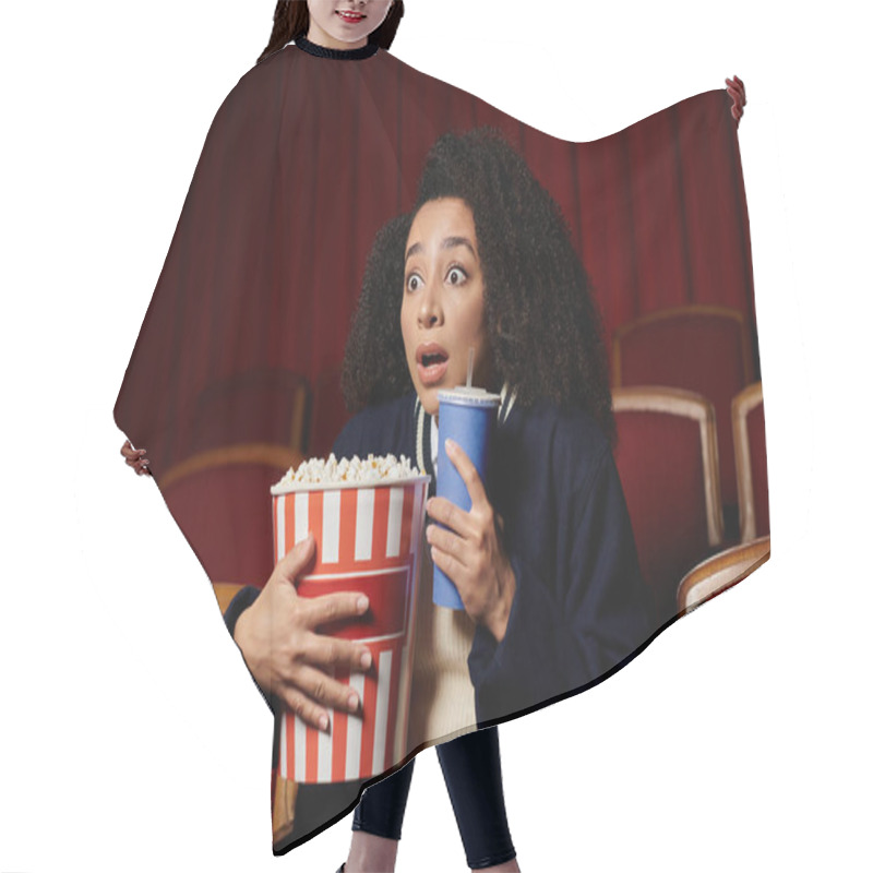 Personality  A Young Woman Watches A Movie In A Theater, Clutching Popcorn And A Drink As She Reacts To A Surprising Scene. Hair Cutting Cape