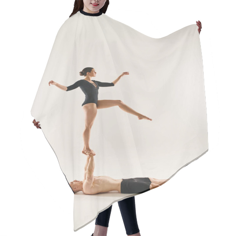 Personality  A Shirtless Young Man And A Woman Performing Acrobatic Moves While Suspended In The Air. Studio Shot On A White Background. Hair Cutting Cape