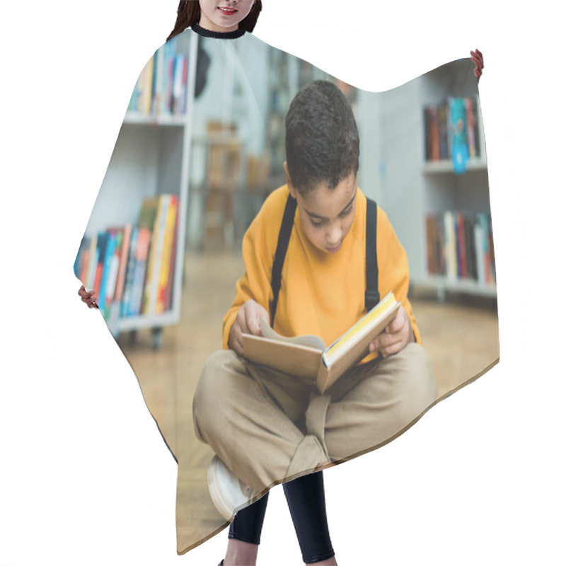 Personality  Cute African American Boy Sitting On Floor And Reading Book  Hair Cutting Cape