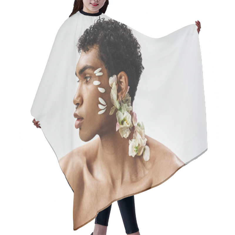 Personality  A Young, Muscular African American Man Poses Against A Grey Background, Adorned With Delicate White Flowers On His Face And Neck. Hair Cutting Cape