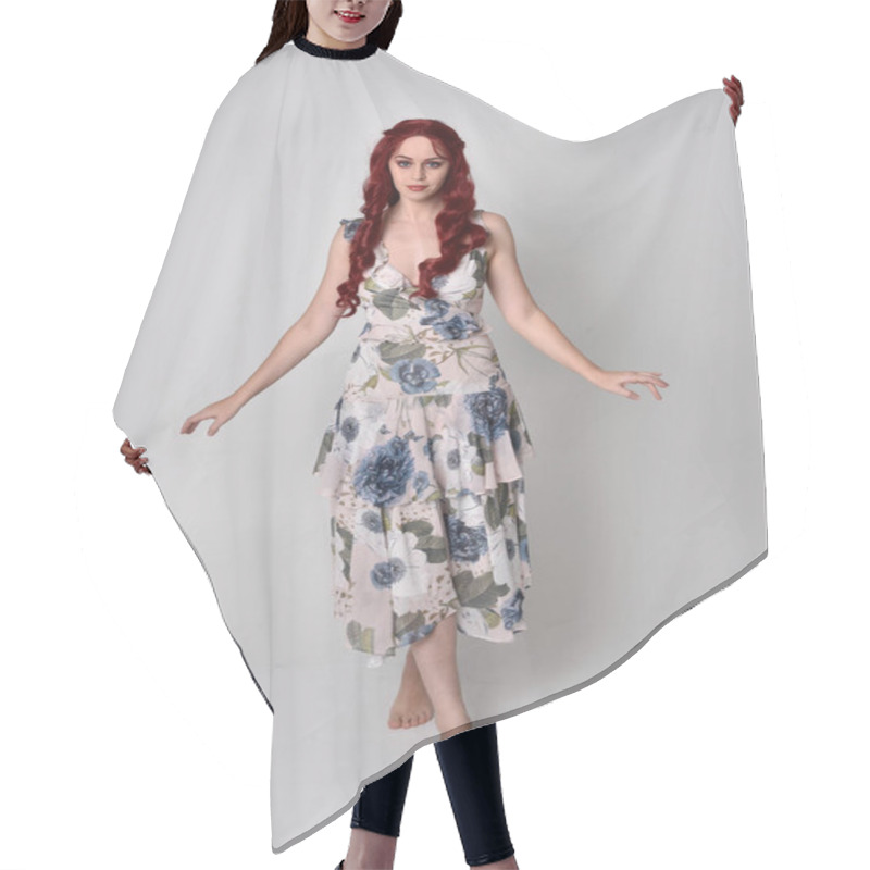 Personality  Portrait Of A Beautiful Woman With Red Hair Wearing  A  Flowing Floral Gown.  Full Length Standing Pose, Isolated Against A Studio Background Hair Cutting Cape