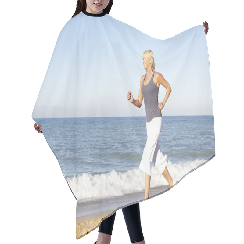 Personality  Senior Woman In Fitness Clothing Running Along Beach Hair Cutting Cape