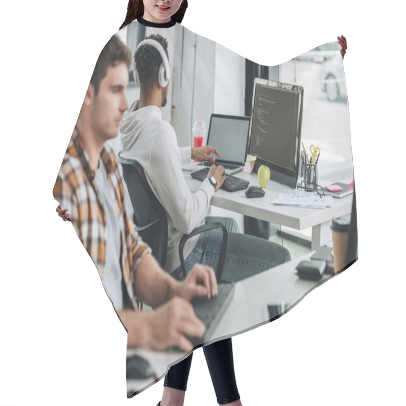 Personality  Selective Focus Of Programmer Working Near African American Colleague In Headphones Hair Cutting Cape