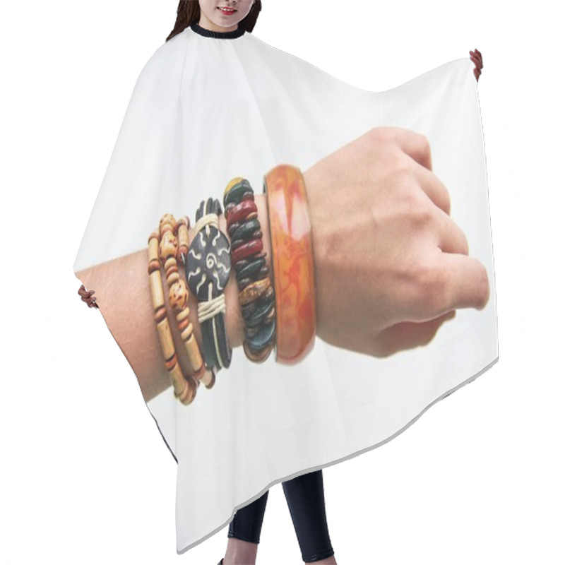 Personality  Ethnic Bracelets On A Thin Female Hand On White Background Hair Cutting Cape