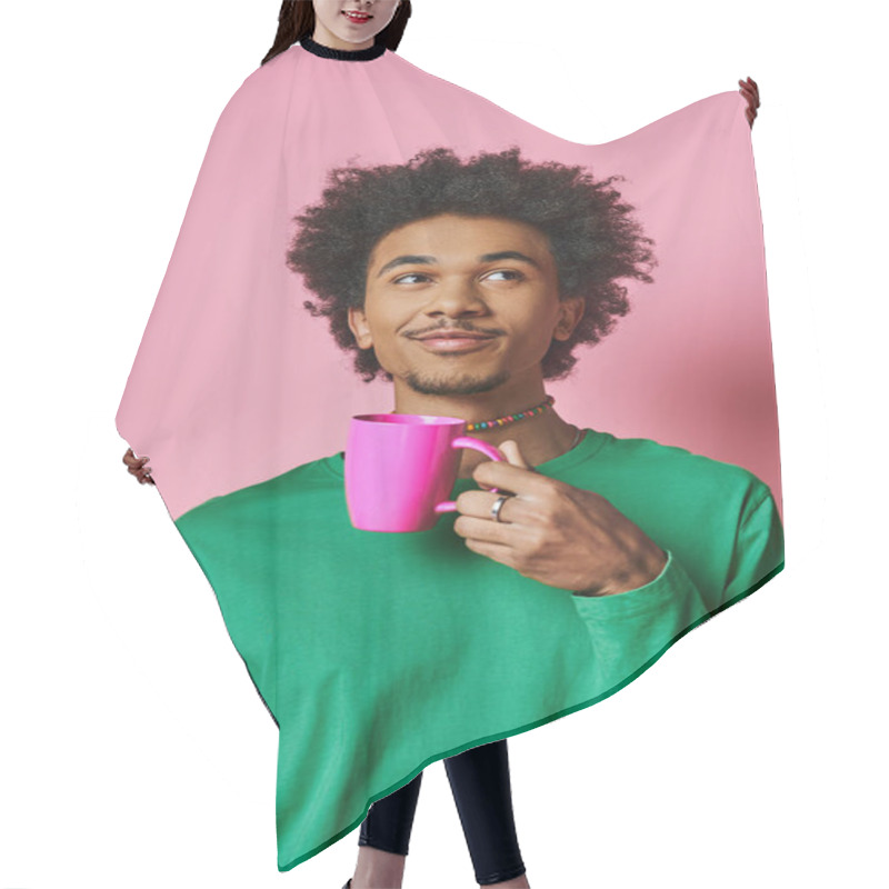 Personality  A Cheerful, Young African American Man In Casual Wear Holds A Cup In Front Of His Face Against A Pink Background. Hair Cutting Cape